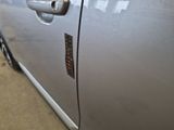 a close up of a car door handle with a sticker on it