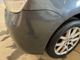 a close up of a car ' s rear end with a tire