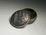 an image of a silver box with a coin inside of it