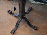 a metal table with a black top and a black base