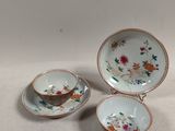 three small cups and saucers are sitting on a table