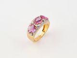 a pink sapphire and diamond ring on a white background