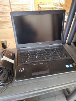 a laptop computer sitting on top of a table