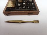 a small wooden box with a pair of scissors next to it