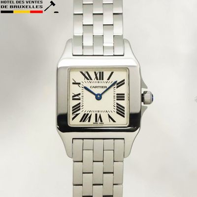 a silver watch with roman numerals on the face