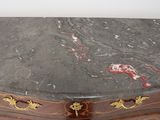 a marble top table with gold decorations on it