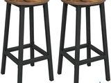 a pair of wooden stools with black legs on a white background