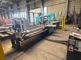 an image of a large machine in a warehouse with lots of wood