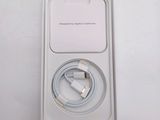 a white box with a charger and a cable in it