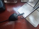 a pair of scissors sitting on a table next to a pair of scissors