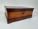 an old wooden box sitting on top of a white surface