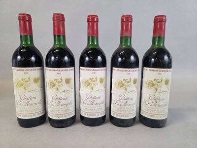 four bottles of wine are lined up on a table