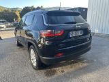 the back of a black jeep compass parked in a parking lot