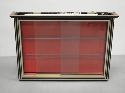 a black and red display case with red glass doors