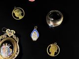 many different types of jewelry displayed on a black surface