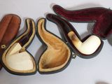 several different types of smoking pipes are lined up in a case