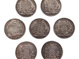 six anciennes pièces d'argent britanniques sur fond blanc