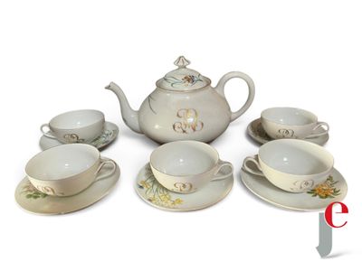 several cups and saucers are arranged in a circle on a white surface