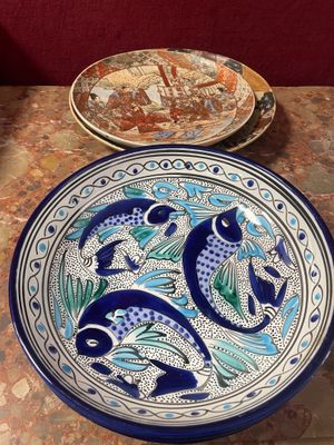 a blue and white plate with a fish design on it