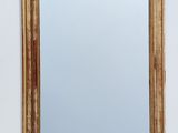 a mirror hanging on the wall above a sink