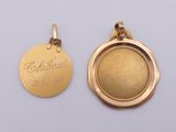 a close up of two gold lockes with a gold disc