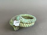 an image of a green rope ring with a tag on it