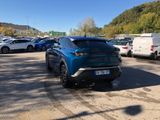 a blue suv parked in a parking lot with other cars