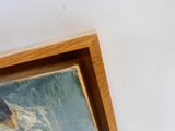 a picture of a painting of a dog hanging on a wall