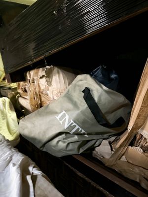 a bag sitting on top of a bed in a room