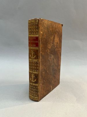 an old book sitting on top of a table next to a white background