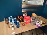 a table with a lot of bottles and spoons on it