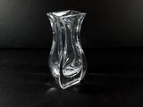 a clear glass vase sitting on top of a black table