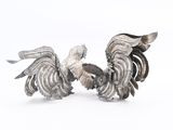 pair of silver plated rooster figurines on white background