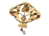 an image of a close up of a brooch with a pearl