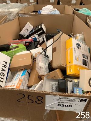 a cardboard box full of electronic devices and other items