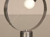a metal object with a white ball inside of it