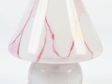 a white lamp with a pink shade on top of it