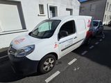 a white van parked in front of a white building