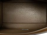the inside of a brown purse with a zipper on it