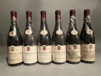 six bottles of wine are lined up in a row on a table