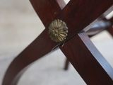 a close up of a wooden chair with a metal knob