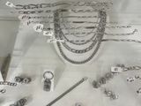 a display case with a lot of silver jewelry on it