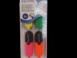 three different colored pens in a package on a black background
