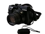 a black camera with a strap attached to it