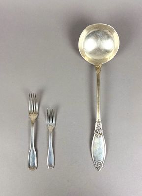 a spoon, fork, and spoon rest on a table