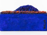 painting of a blue box with a pile of dirt on top of it