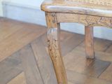 a wooden chair that is sitting on a parquet floor