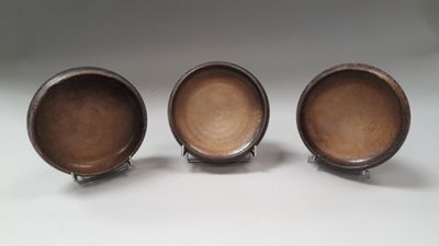 three brown bowls sitting on top of each other on a table