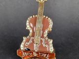 an image of a miniature violin sitting on top of a table