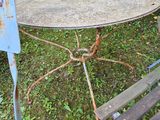 a small table and two chairs in the yard